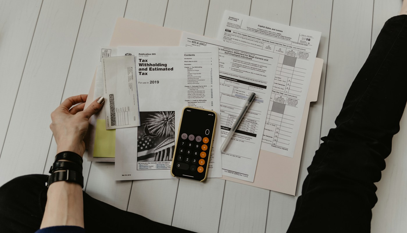 A desk with a calculator, notebook and pen used during a family cash-flow planning session