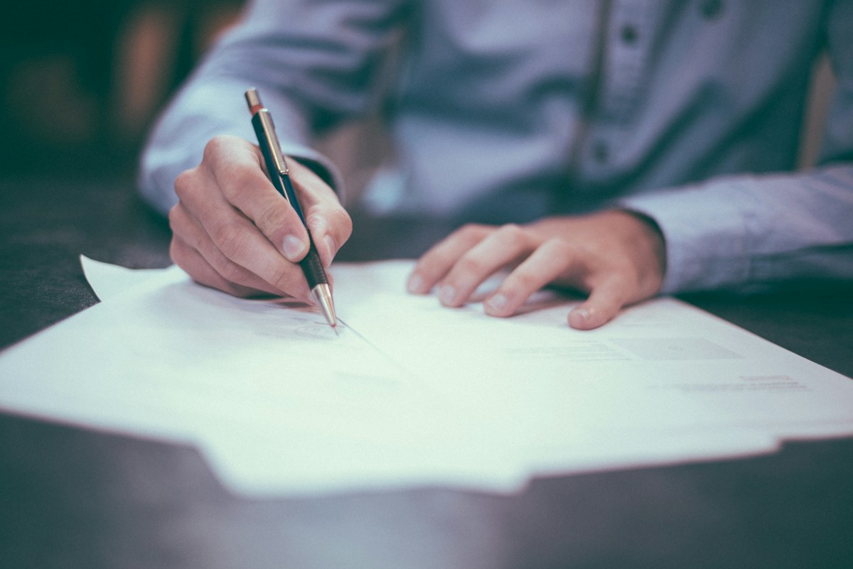 Open notebook and documents on a desk during a family financial-planning consultation